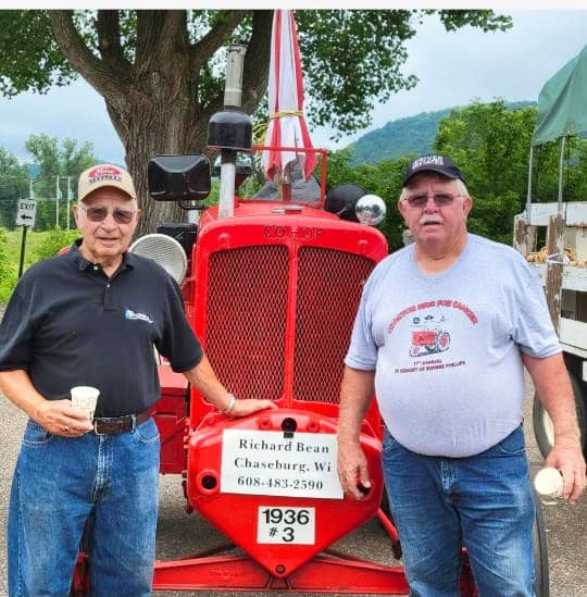 Chaseburg Area Cancer Walk participants standing in front of a red tractor